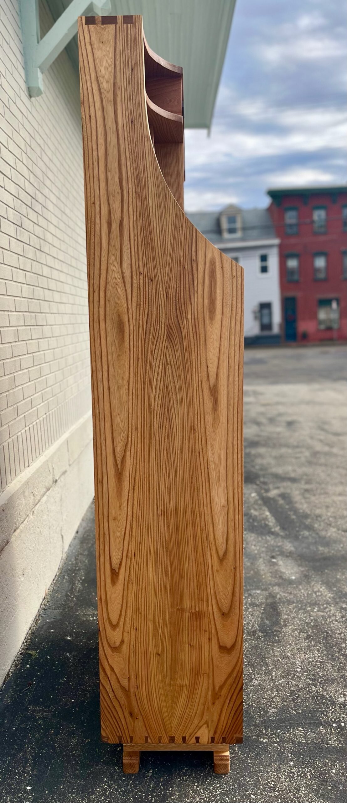 swooping left profile showing entrway cabinet's height and hand cut box and dovetail joints at the top and bottom of the piece. 