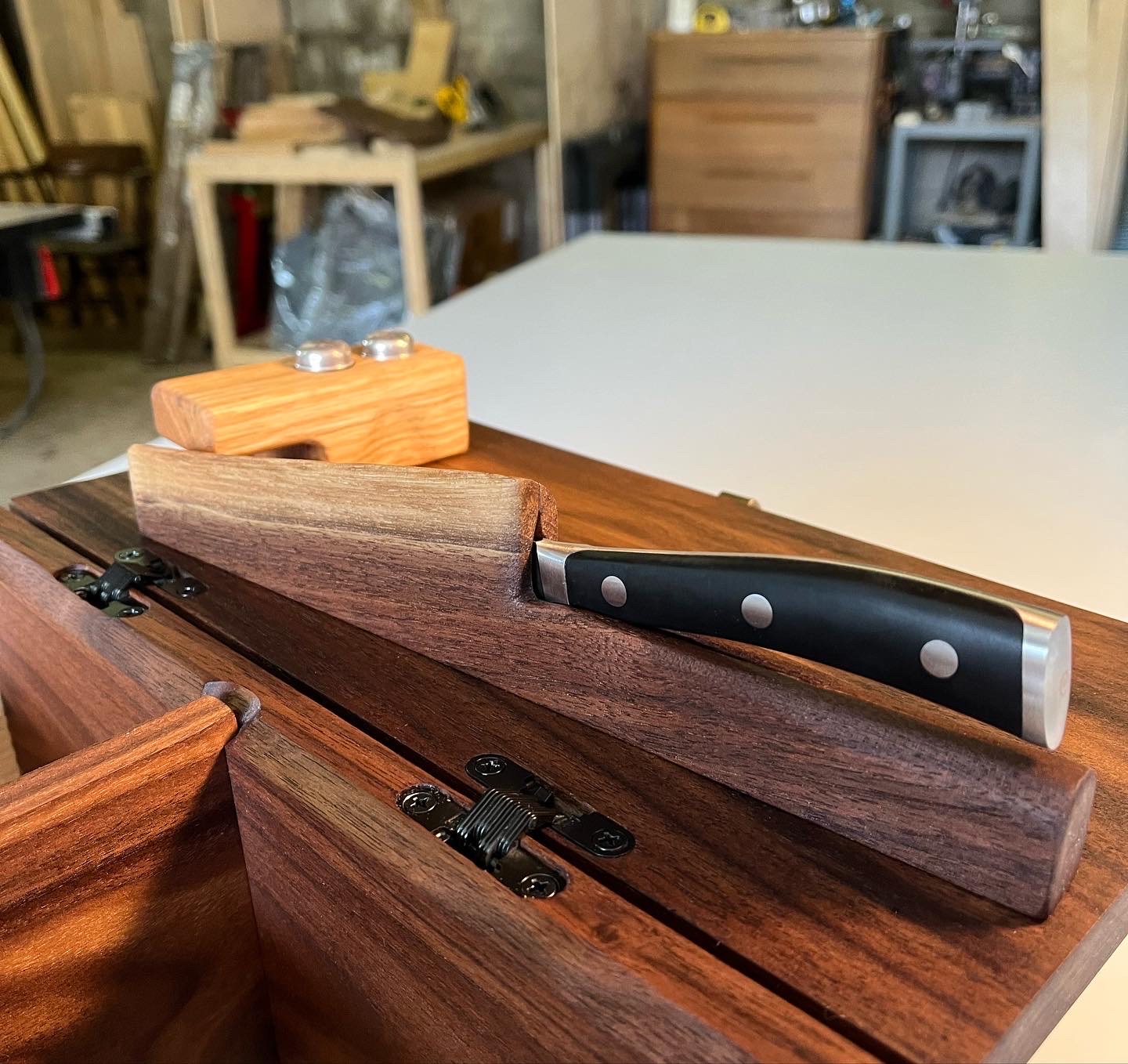 Bespoke walnut sapwood knife holder with knife snuggly inside it.