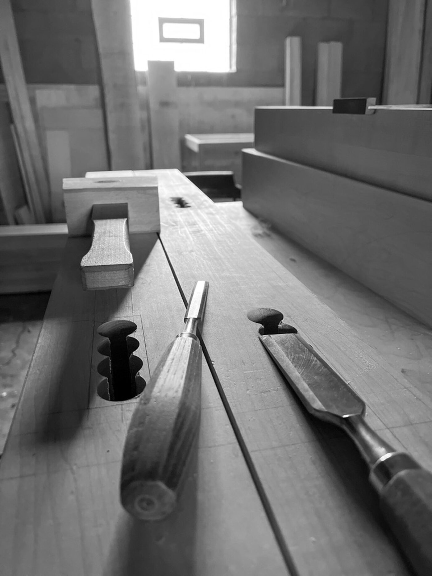 two chisels and a wooden mallet. black-and-white image.