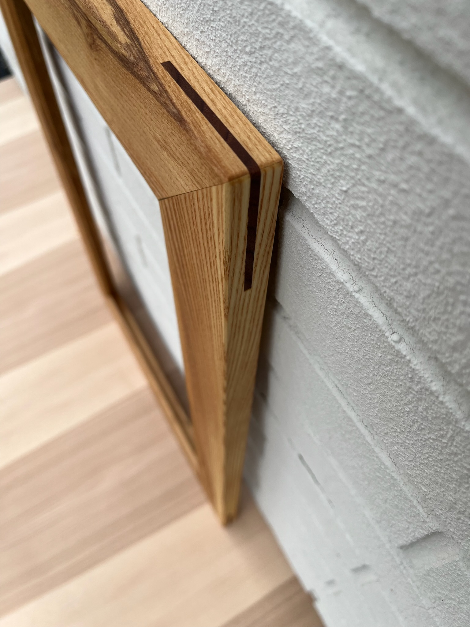 Butternut wood frame with walnut splines. Distinct wood grain with various gradation of natural colors.