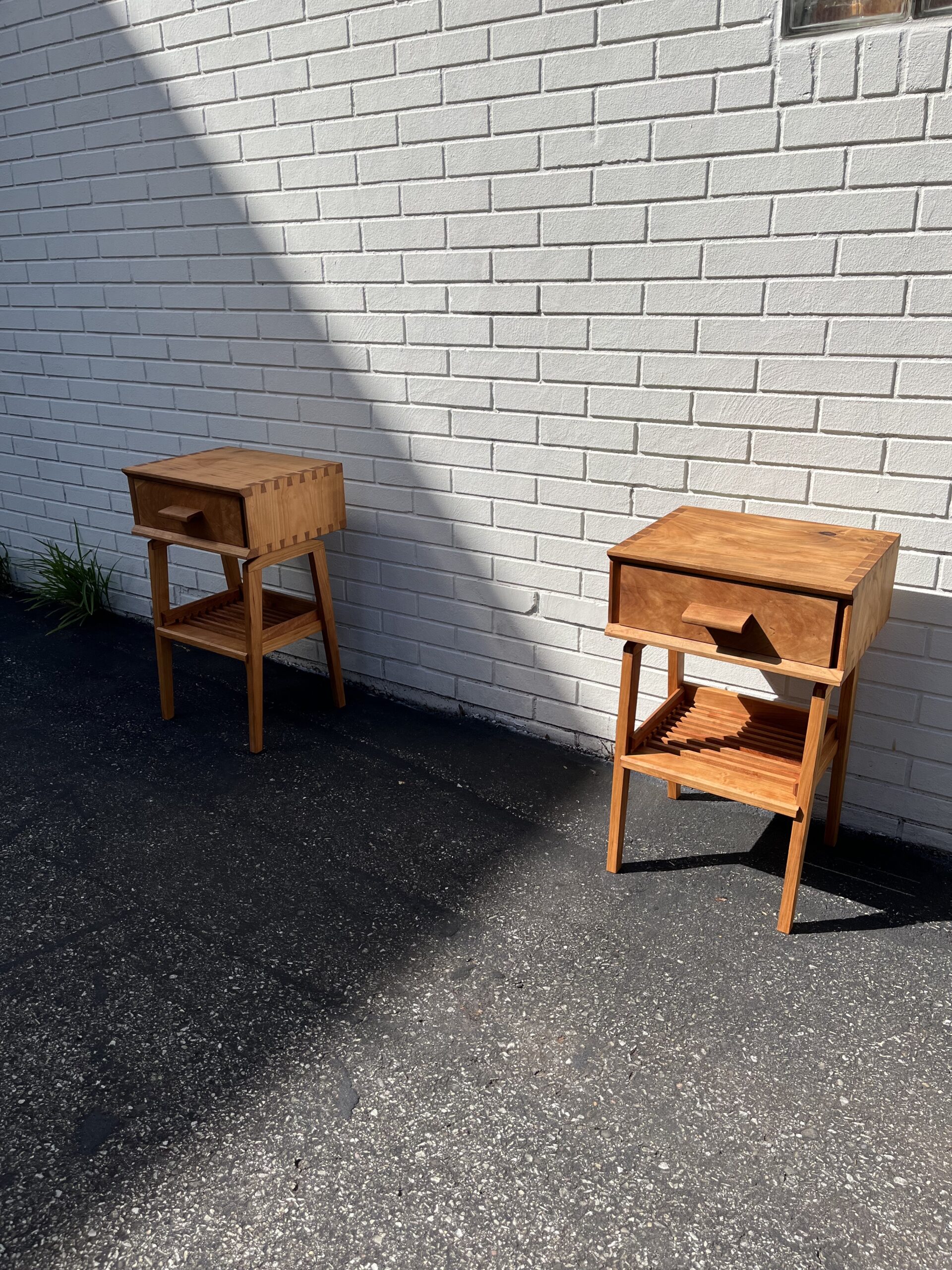 night stands next to white brick wall of artist studio
