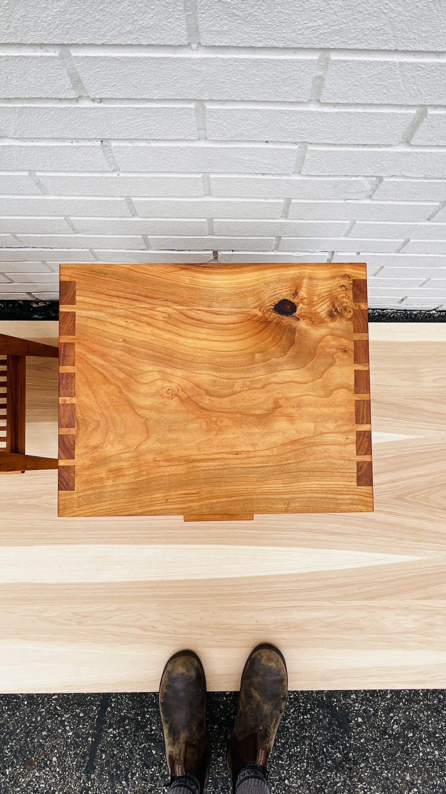 Nightstand made from cherry wood, overhead. Swirling wood grain and dovetails on full display.